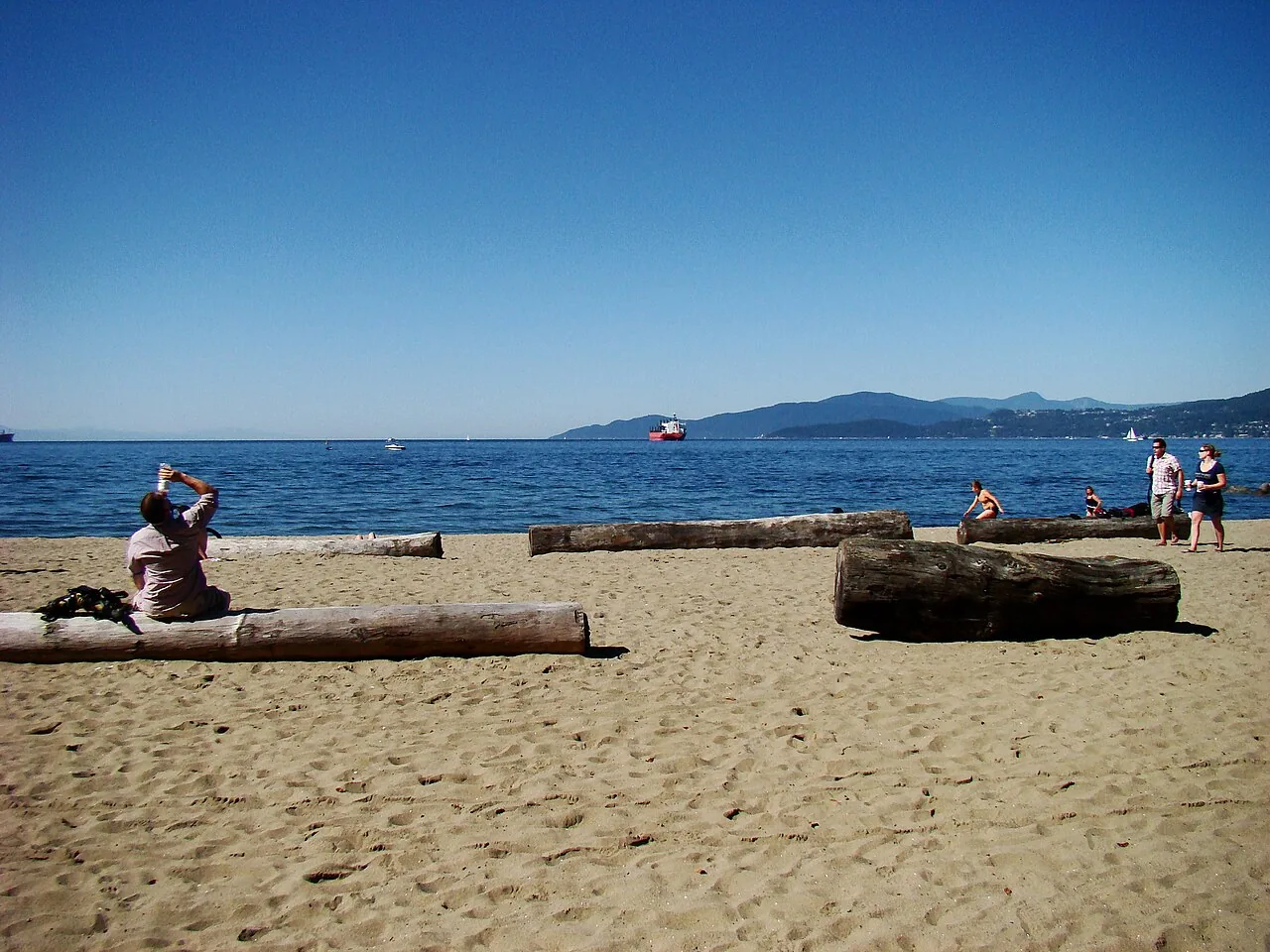 Sand, driftwood logs and ocean at Third Beach in Stanley Park